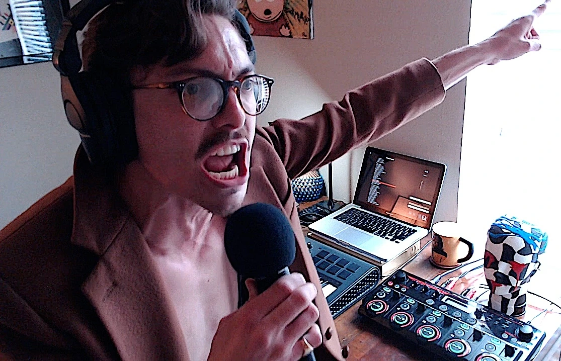 Marc Rebillet performing with microphone in a home studio