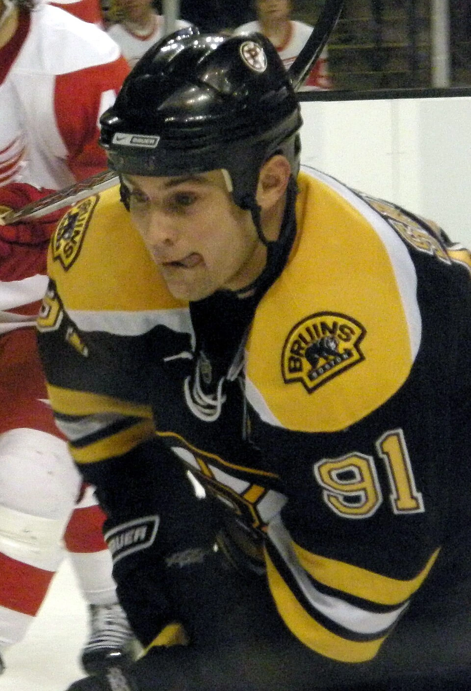 Marc Savard in a Boston Bruins game, wearing a black and gold Bruins jersey and helmet.